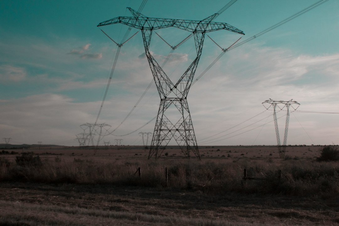 Power lines across a landscape representing clean-energy grid investment