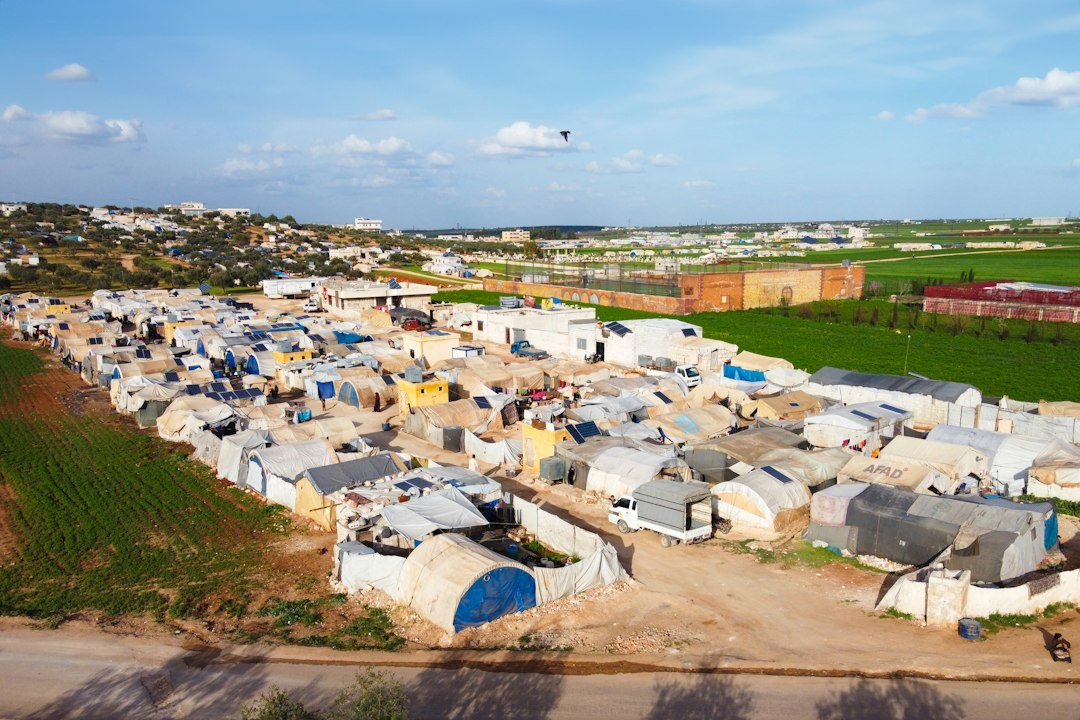 Aerial view of a displacement camp representing Sudan's humanitarian crisis