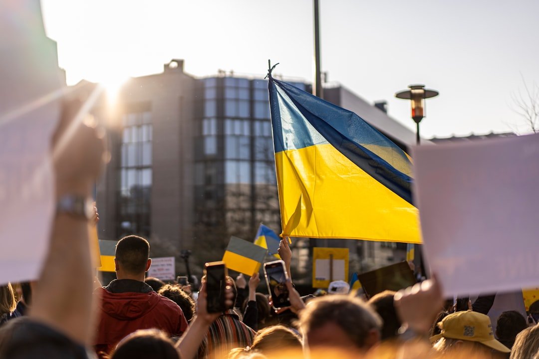 People holding Ukrainian flags during a public gathering