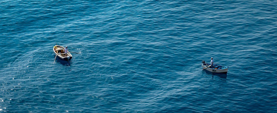 Small boats on open water illustrating dangerous migration routes across European sea routes