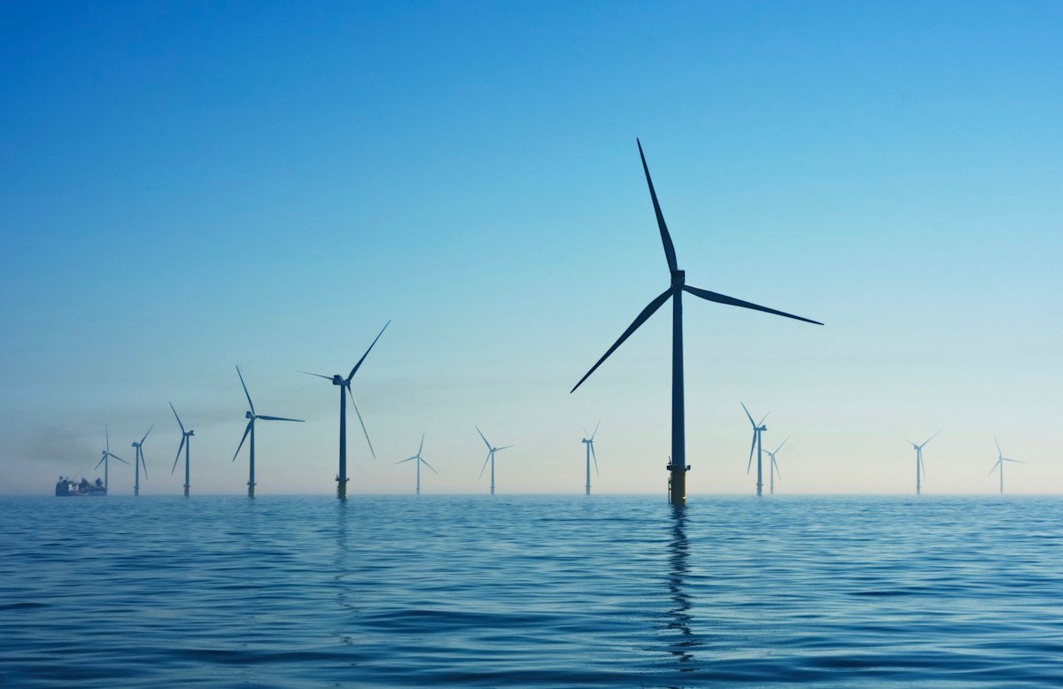 Illustrative wind turbines representing clean energy; not a photograph of the pre-COP meeting.